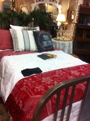 beautifully decorated brass bed, with the holiday spirit.