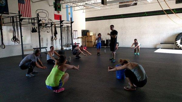 Coach Alex leading the group stretch and warm up.