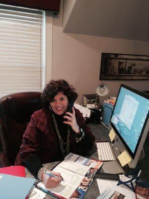 Sheri Clarke, hard at work, booking land and sea vacations!