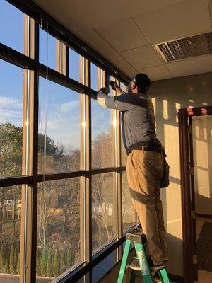 Jeffery cleaning office windows in Cleveland.