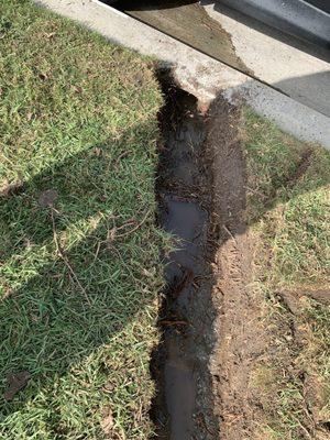 Irrigation ditch where clogged pipe was removed.