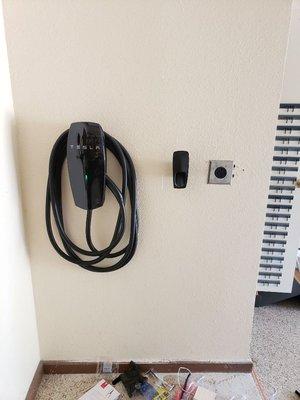 Installed Tesla car charger and concealed 240 volt receptacle in the wall.