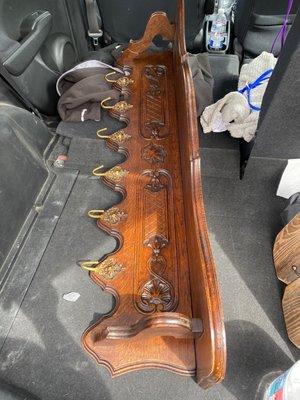 Antique English hanging coat rack with shelf.