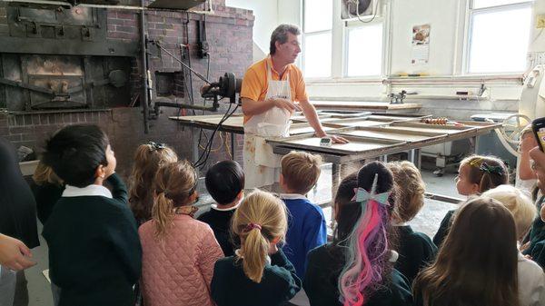 The Pre-K children are learning how neighborhood favorite, Liguria Bakery focaccia is made.