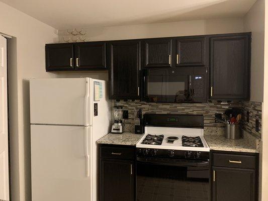 Kitchen cabinet makeover from honey oak to modern black and gold