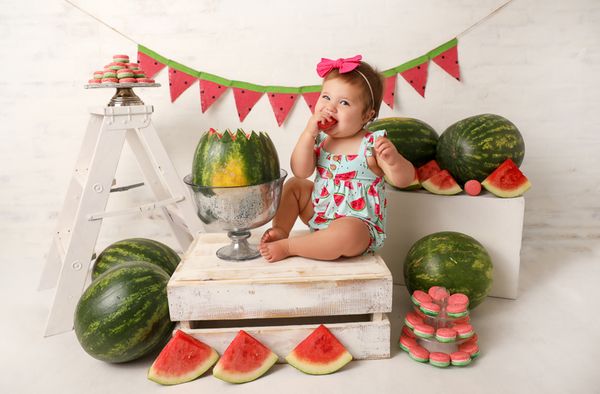 Baby photographer cake smash photography Portsmouth New Hampshire one year olbaby girl in watermelon outfit surrounded by watermelon eating