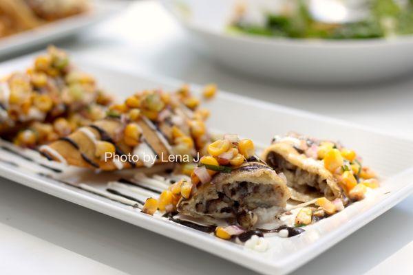 Forest Mushroom Empanadas ($13) - huitlacoche vinaigrette, tomatillo corn salsa, cheese, crema