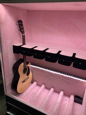 Guitar Vault that holds up to 6 guitars with 1 slot for acoustic or electric.