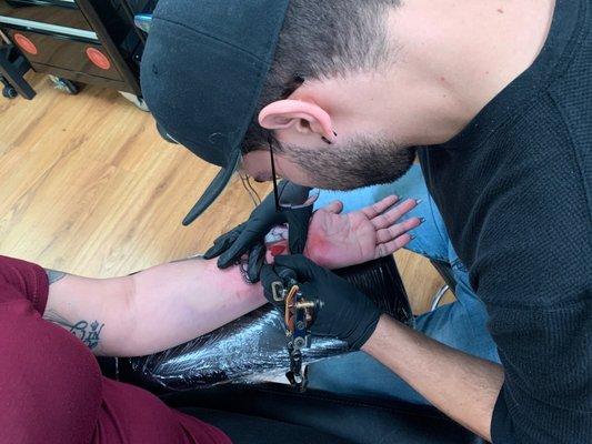 Tony tattooing my gf. Queen crown with red Queen playing card heart and the "Q"