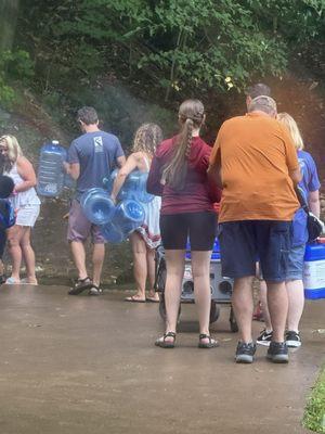 People waiting in line to fill water bottles