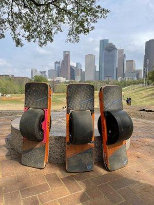 Onewheel's chilling in front of the Houston Skyline at Eleanor Tinsley Park