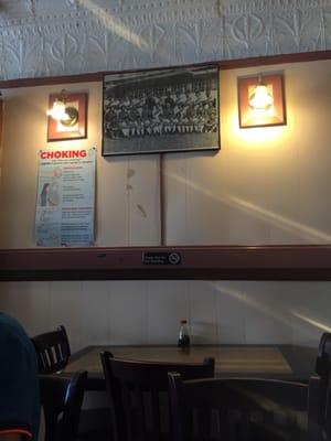 A picture of the wall where a Peruvian soccer team picture and a poster about first aid both hang.