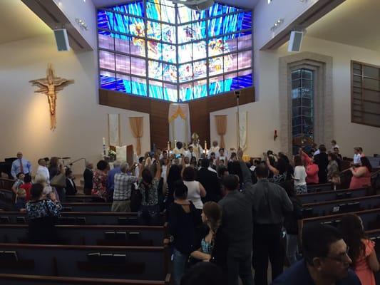 Ugly church with meaningless stained glass. No crucifix. Tabernacle relegated to the side.