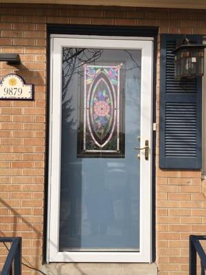 After: I installed a storm door and cut out center of front door to install stained glass.