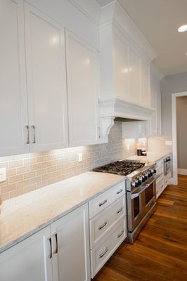 Wine River granite fabricated by Granite Accents is beautiful with the white cabinets.