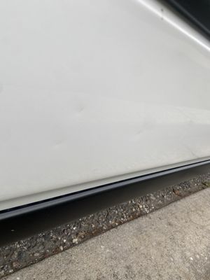 Multiple dents along the side of car