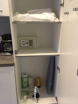 Closet with extra linen, blankets, small ironing board, iron and safe