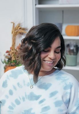 Angled bob haircut with layers, blowdry style with waves.