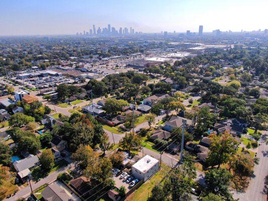 Showing the Cooper CPA Group building on the bottom with Houston skyline in the back. A partial view of the Heights.