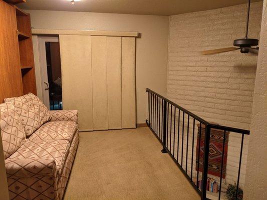 A Murphy bed lurks behind that couch in this loft.