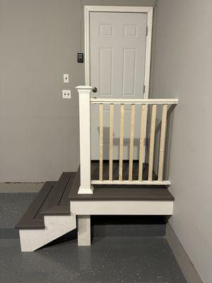 Interior garage entrance steps and small platform with handrail