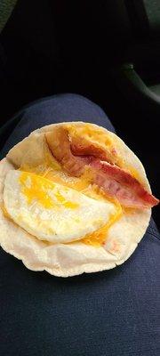 This is a bacon egg and cheese wrap with one slice of bacon