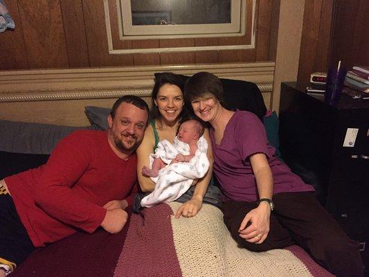 Tiffany, midwife, tucking in a family after the safe home birth of their first girl in Colorado Springs.