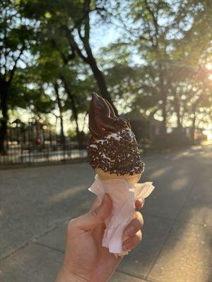 Vanilla soft serve with half sprinkles and half chocolate dip