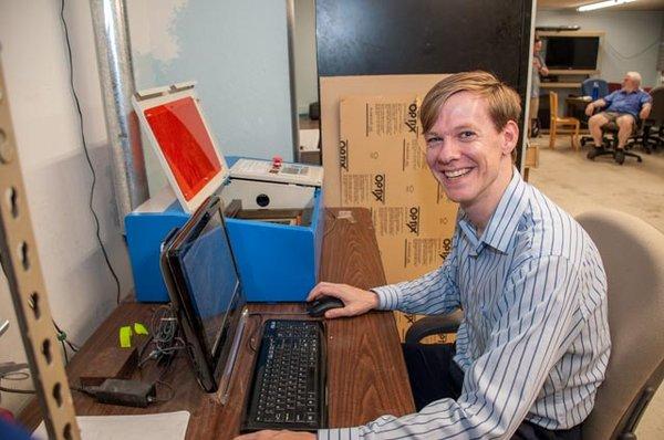 Founder Tom sets up the laser cutter.