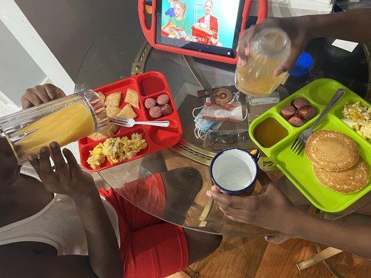 Kids enjoying breakfast while watching iPad