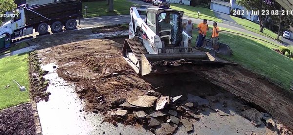 Process of tearing out old and cracked asphalt driveway at my home.