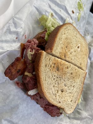 Pastrami on toasted rye with horseradish sauce and bacon. Delicious!