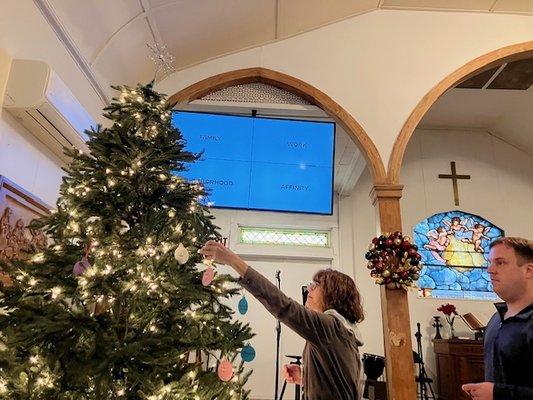 Hanging prayer ornaments during Advent season.