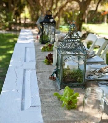 Bridal party table. White rustic doors with burlap runner, mason jars, succulents, and lanterns