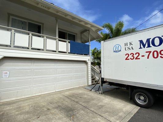 HK Movers carefully move things out from upstairs.