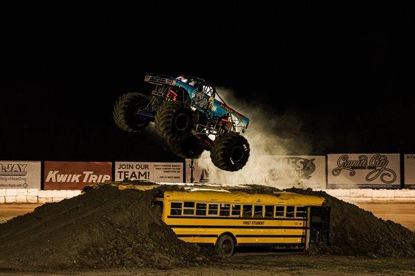 Bearly Tame Monster Truck leaps over a school bus during an Action Photography session with Photopoulos Family Photography, LLC.