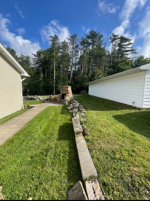 Before photo of an old concrete retaining and outdoor brick oven that was demolished and removed