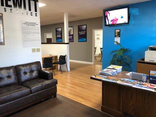 Waiting area comes equipped with comfortable seating, complimentary refreshments, and televised entertainment.