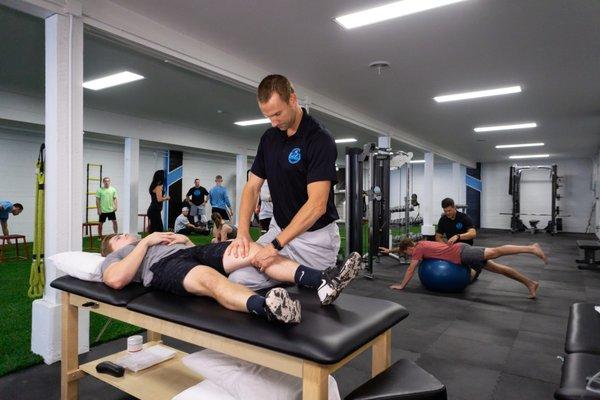 Physical Therapist Kevin Wright performing manual therapy on athlete.