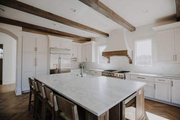 French county style kitchen with custom Weber cabinets. Range hood and island painted in a coordinating custom stain.