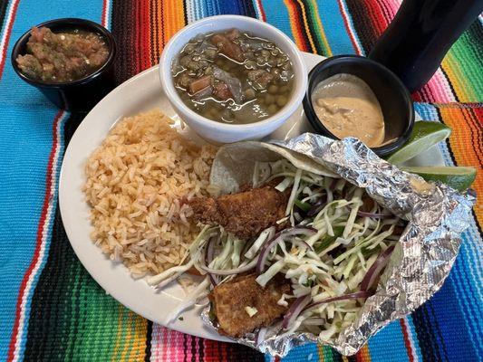 The tilapia fried fish tacos with chipotle cream sauce cabbage and pico de gallo served with Spanish rice and a side of lentejas.