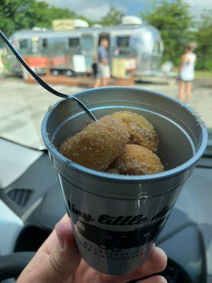 Cinnamon sugar Tiny Little Donuts in a cup! With the TLD Airstream in the background.