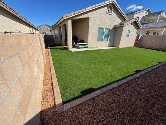 Completed paver border, new artificial turf and gravel