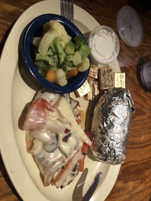 Smothered chicken, baked pot and California veg