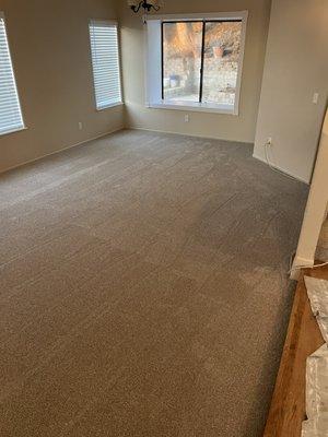 Installed carpet in living room.