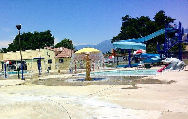 The children's wading pool, giant water slide, and  big frog tongue slide into the children's pool plus unique water features at Perris Hill