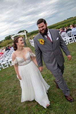 Bride and groom walking away after saying "I do"