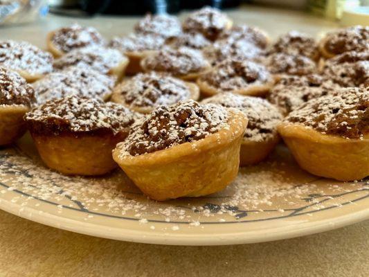 Pecan tarts with powdered sugar sprinkle