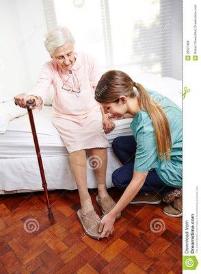 Caregiver helping senior citizen out of bed