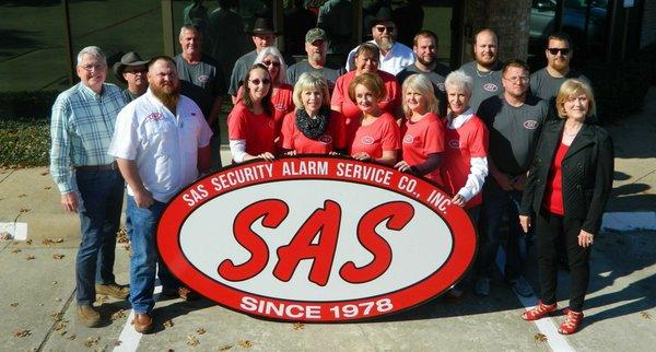 SAS staff with new sign